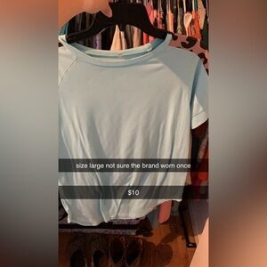 A blue shirt with cheetah print on the sleeves